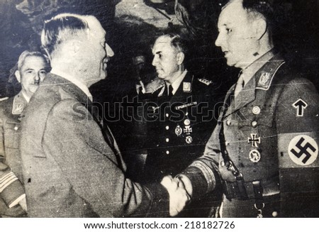 GREMANY - CIRCA 1930s: Adolf Hitler shakes hands with Victor Lutz - Chief of Staff of the SA after murder of Ernst Rohm. Assault troops (Sturmabteilung), abbreviated as SA; also known as \