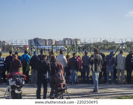 UKRAINE, KYIV - September 28, 2014: Visitors to the museum watching a passenger plane taking off. -- National Aviation Museum is the youngest military-technical museum in Ukraine.