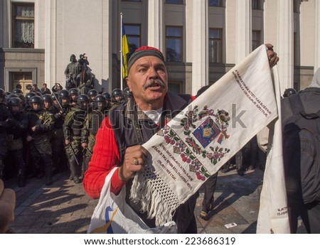 KIEV , UKRAINE - October 14, 2014: Clashes near Verkhovna Rada. The man with the embroidered towel stands between the radicals and the police to prevent a collision.