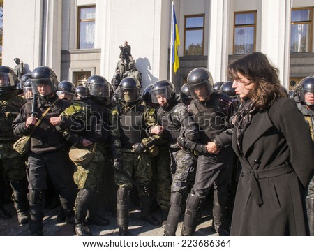KIEV , UKRAINE - October 14, 2014: Clashes near Verkhovna Rada. The former head of the anti-corruption committee Tatyana Chornovil stands between the radicals and the police to prevent a collision.