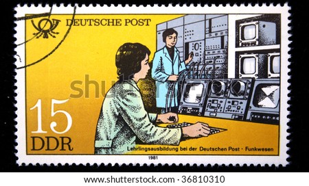 German Democratic Republic - CIRCA 1981: A stamp printed in GDR shows student under direction of the instructor works at the modern enterprise of communication, stamp from series, circa 1981