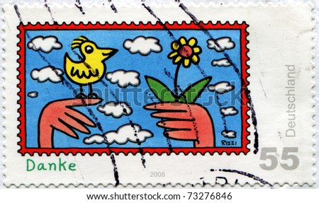 GERMANY - CIRCA 2008: A stamp printed in Germany shows two hands held out a flower, another birdie, and word \