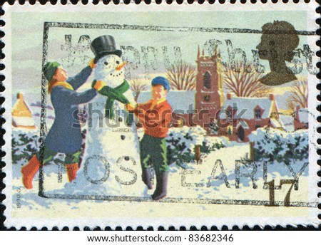 GREAT BRITAIN - CIRCA 1990: A stamp printed in Great Britain shows children are building a snowman, series is devoted to Christmas, circa 1990