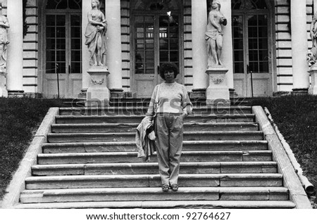 young woman on the steps of the royal palace at Peterhof, Leningrad, USSR, 1984