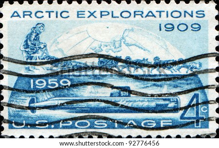 USA - CIRCA 1959: A stamp printed in USA honoring Arctic Exploration shows  dog sled with rider and a submarine under the ice, circa 1959