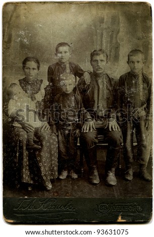 RUSSIA - CIRCA end of the XIX - the beginning of XX century: antique photo shows family of worker with four children, Lugansk, Russian Empire, Ukraine Russian text: Yukhnovskiy (photographer), Lugansk