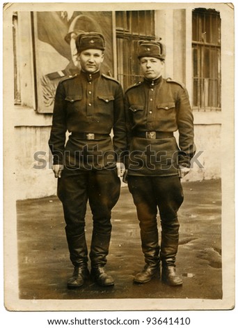 USSR - CIRCA 1959: Postcard shows Two Soviet soldiers against the barracks, of the USSR, 1959