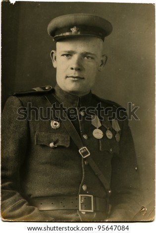 AUSTRIA - CIRCA 1946: Guard Staff Sergeant Soviet Army, was awarded three medals, Austria, 1946
