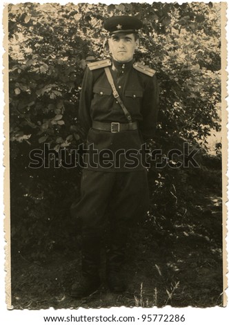 GERMANY - CIRCA 1955: Soviet Army lieutenant against a background of bushes, circa 1955
