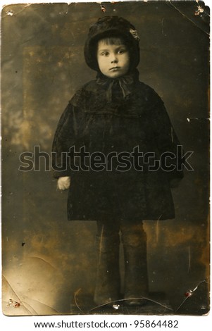 USSR - CIRCA 1940: Studio portrait of little girl with a coat, hat and boots, Elan, Volgograd Region, Russia, circa January 1940, the girl\'s name- Nina Shkurskaya, age 4 years