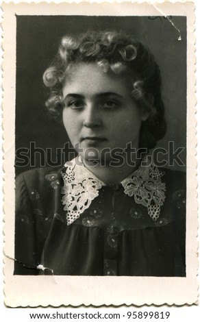 USSR - CIRCA 1952: Portrait of a young woman in a dress with lace collar, circa 1952