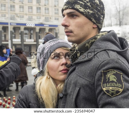 KIEV, UKRAINE - December 6, 2014: Girl resting her head on chest of Soldier from the \