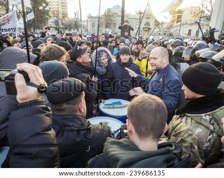 KIEV, UKRAINE - December 23, 2014: Deputy Borislav Bereza tries to calm protesters -- To break through the cordon of police and four special forces in full uniform