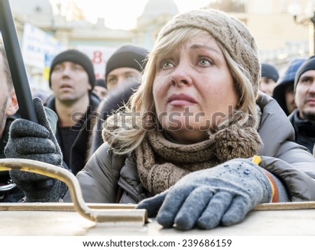 KIEV, UKRAINE - December 23, 2014: Woman protesting in tears asking for help MP Borislav Bereza. -- To break through the cordon of police and four special forces in full uniform