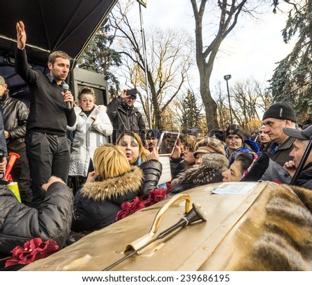KIEV, UKRAINE - December 23, 2014: Deputy Vladimir Parasyuk tries to calm protesters -- To break through the cordon of police and four special forces in full uniform,