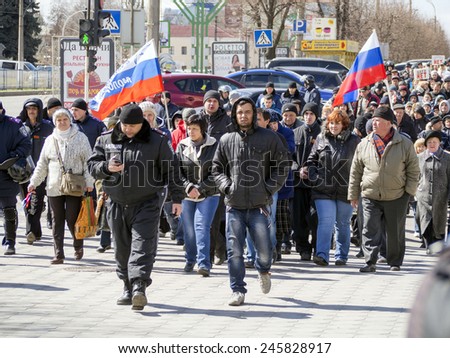 LUGANSK, UKRAINE - April 5, 2014: Pro-Russian activists followed by the Ukrainian police are moving towards the building of the Security Service of Ukraine in Lugansk.