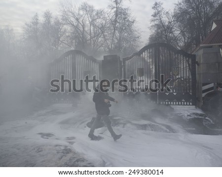 KIEV, UKRAINE - February 2, 2015: Photographer misses extinguished tires near gate of Ministry of Defense of Ukraine in Kiev. Volunteers of Aidar battalion picket in front of the Ministry of Defense