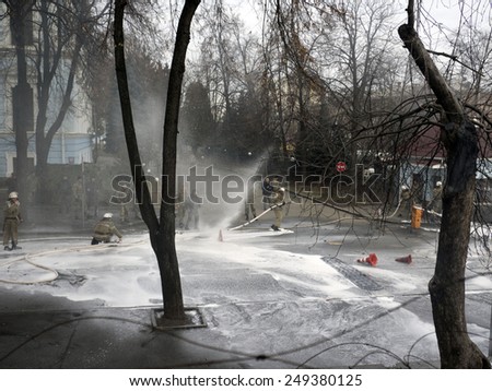KIEV, UKRAINE - February 2, 2015: Firefighters are trying to bridge the gap hose hose, which made fighter Volunteer Battalion Aydar into the courtyard of the Ministry of Defense of Ukraine in Kiev.