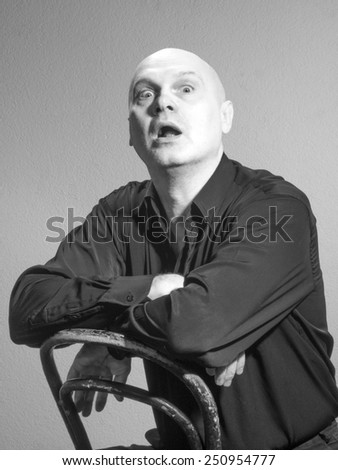 Studio black and white portrait portrait caucasian bald men. Emotions. Wonderment