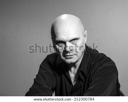 Studio black and white portrait portrait caucasian bald men. Emotions. Surly