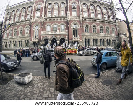 KIEV, UKRAINE - Feb 25, 2015: A man walks past a rally near the National Bank. -- Activists of the \