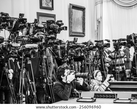 KIEV, UKRAINE - Feb 25, 2015: Photographer press service of the Cabinet of Ministers of Ukraine Andrew Kravchenko (in front) photographs the during a meeting of the Cabinet.