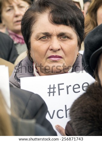 KIEV, UKRAINE - MARCH1, 2015: A woman is holding a homemade banner with .inscription Free Savchenko. Activists demand  release of Ukrainian government forces pilot Nadiya Savchenko from Russian prison