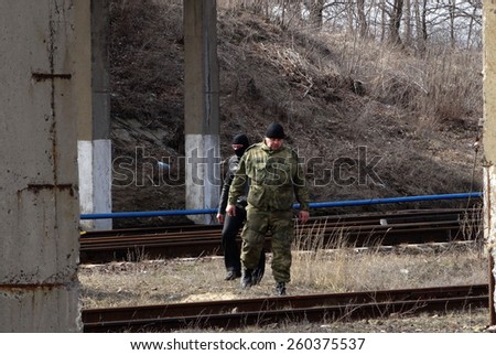 LISICHANSK, UKRAINE - March 12, 2015: Sappers inspect railway near the road bridge. Task Force Security Service of Ukraine together with the police prevented a terrorist act
