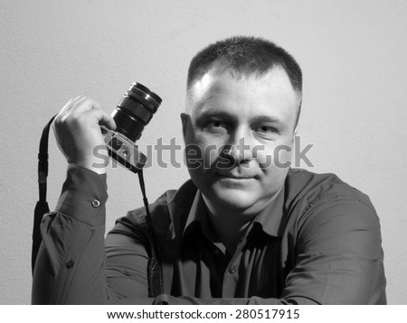 Portrait of young and handsome professional photographer