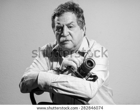 Portrait of middle age and handsome professional photographer