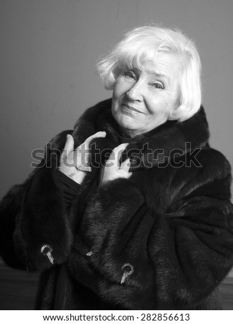 Portrait of elegant senior woman in fur coat