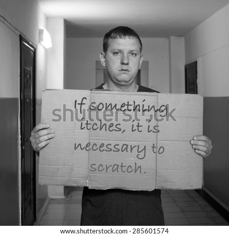 Young man hold self made poster with text \