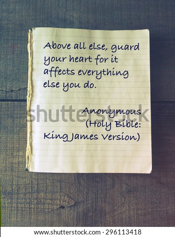 Above all else, guard your heart for it affects everything else you do. Holy Bible. Vintage exercise book on wooden background