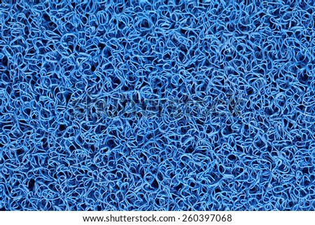 Abstract background of blue carpet or foot scraper or door mat texture.