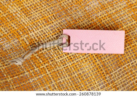 Paper tag blank for text on bamboo weave background.