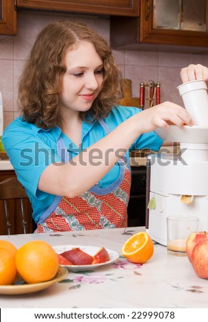 Girl with blender and fruits on home kitchen