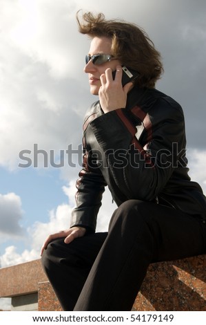 Young man in sunglasses speaks on the phone