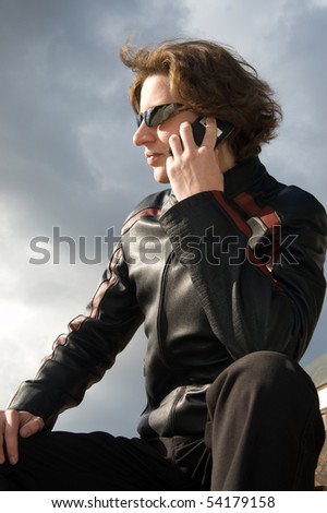 Young man in sunglasses speaks on the phone