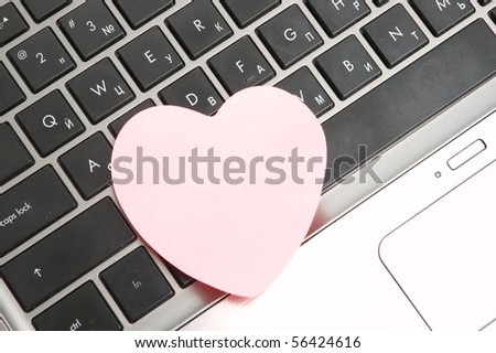 Black laptop keyboard with pink sticker