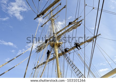 Working in the rigging of a brig