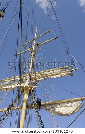 Working in the rigging of a brig