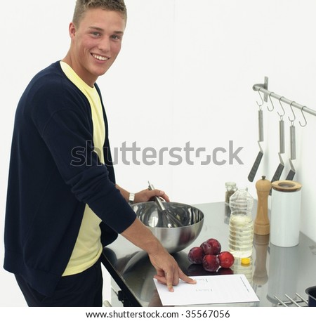 Young man in kitchen