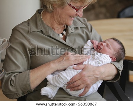 Happy grandma with newborn baby