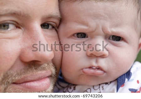 Happy father with angry baby.