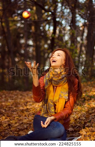 Happy Smiling Young Woman Juggling Apple in the park