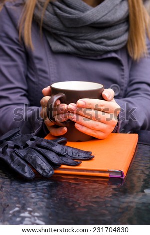 Female hands with hot drink, outdoor