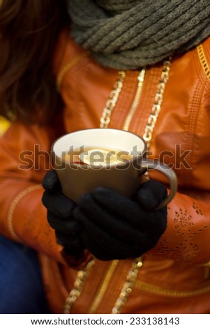 Female hands with hot drink, outdoor