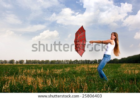 Girl with umbrella. Wind