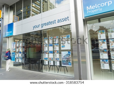 Melbourne, Australia - September 5, 2015: A man reading  advertisements about selling or renting property outside a real estate agency office in Melbourne during daytime.