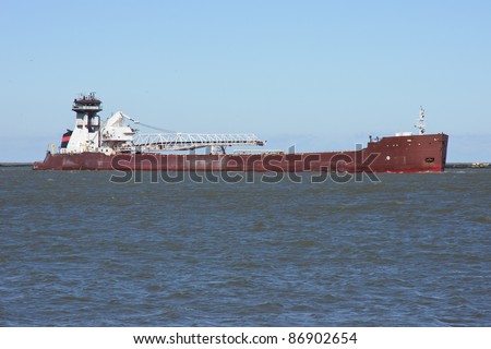 Tug and Barge:  A bulk carrier cargo vessel comprised of a self-unloading barge with a tug boat for power enters the Port of Cleveland, Ohio from Lake Erie
